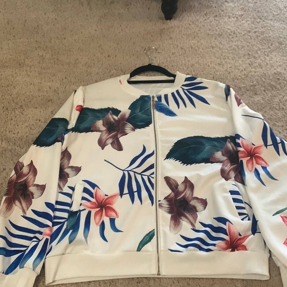 Thin white over jacket with blue pink and purple colors and has pockets